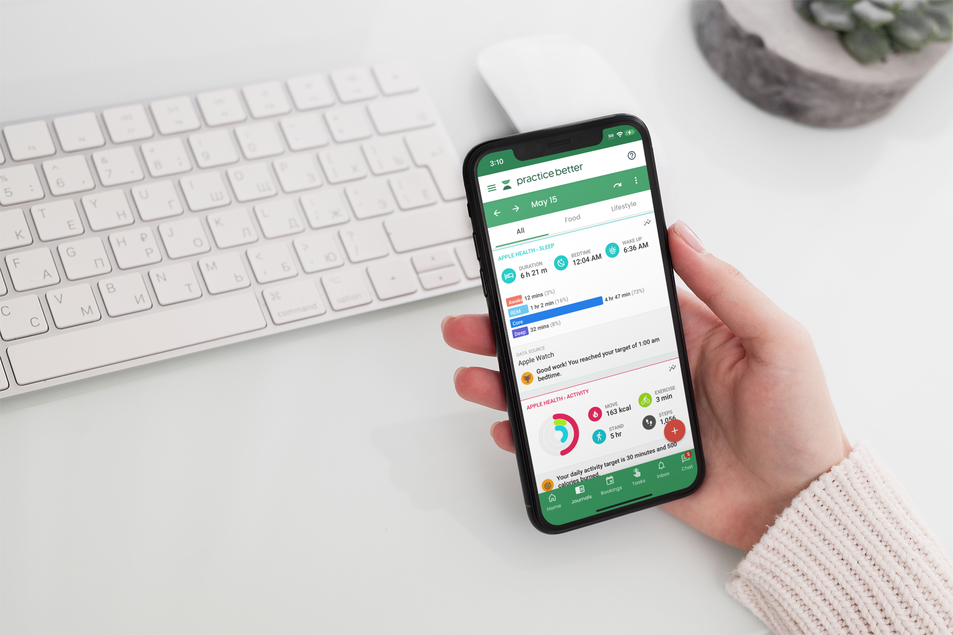 mockup-featuring-a-woman-s-hand-holding-an-iphone-11-pro-over-a-neat-desk-2158-el1